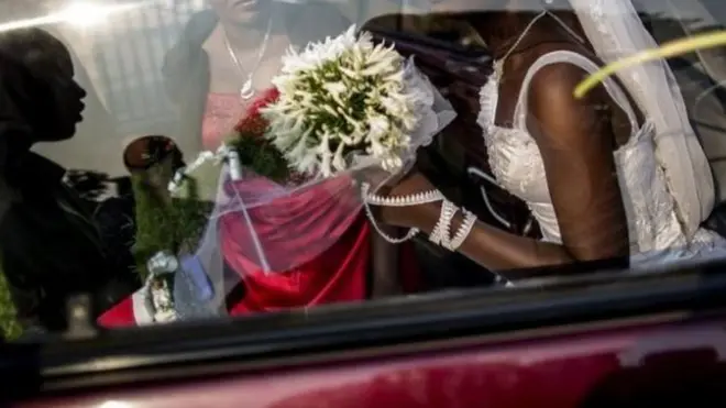Woman inside wedding gown.