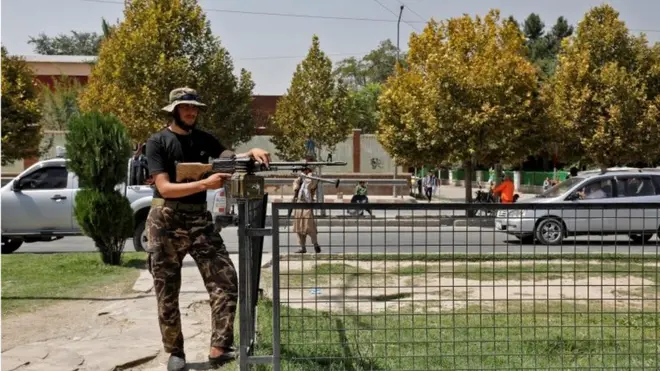 A Taliban fighter stands guard in front of the embassy after the blast
