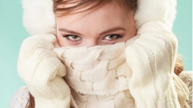 Wearing a scarf over the nose and mouth