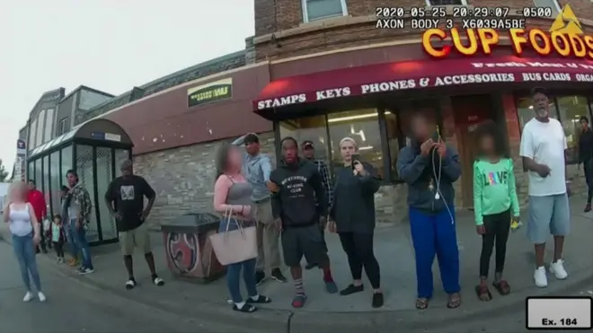 Bystanders watch George Floyd arrested by police. Faces of Darnella and other minors are blurred