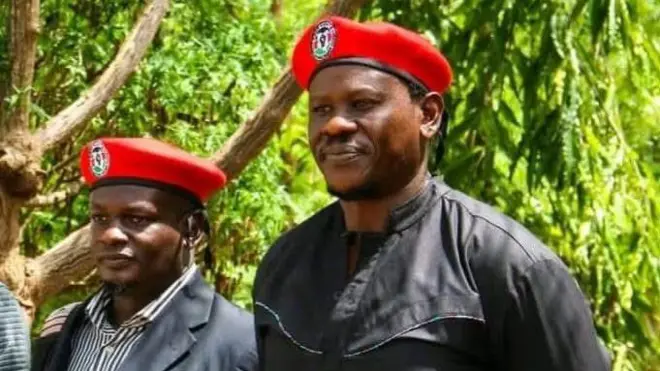 Bob Njagi and Nicholas Oyoo dressed in black clothing and wearing red berets associated with Uganda’s opposition National Unity Platform (NUP), the party of Bobi Wine