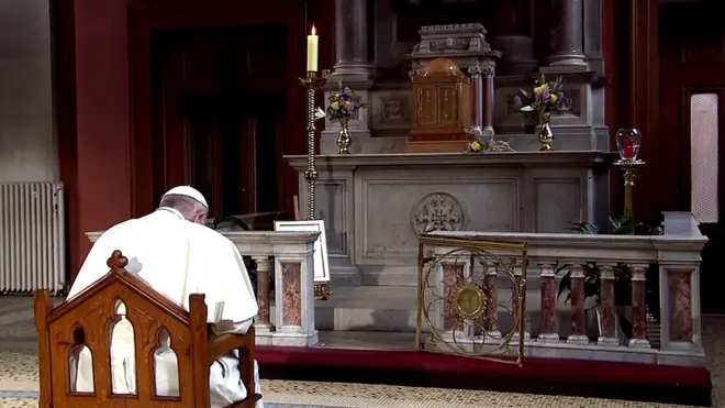 The Pope held a silent prayer in front of a candle that commemorates abuse victims