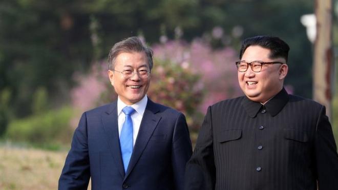 North Korea"s leader Kim Jong Un (R) and South Korea"s President Moon Jae-in (L) walk together after a tree-planting ceremony at the truce village of Panmunjom on April 27, 2018. The leaders of the two Koreas held a landmark summit on April 27 after a highly symbolic handshake over the Military Demarcation Line that divides their countries, with the North"s Kim Jong Un declaring they were at the "threshold of a new history". / AFP PHOTO / Korea Summit Press Pool / Korea Summit Press PoolKOREA SUMMIT PRESS POOL/AFP/Getty Images