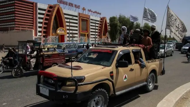Taliban fighters in Kandahar celebrate the departure of US troops