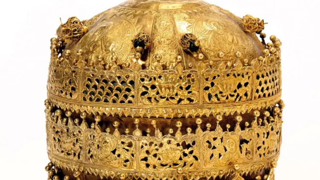 This crown is admired for its filigree designs and religious embossed images