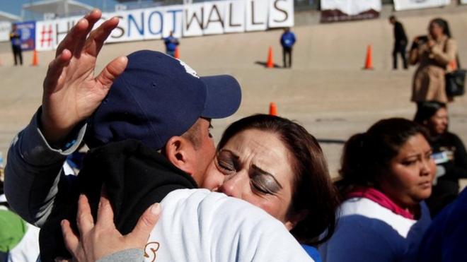 Familiares abrazándose en la frontera de Estados Unidos y México.