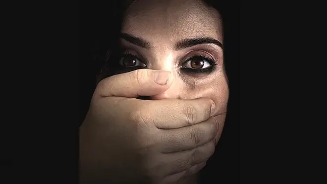 Woman with hand over her mouth