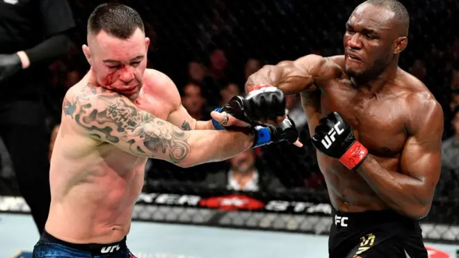 Kamaru Usman of Nigeria punch Colby Covington for dia UFC welterweight championship bout during di UFC 245