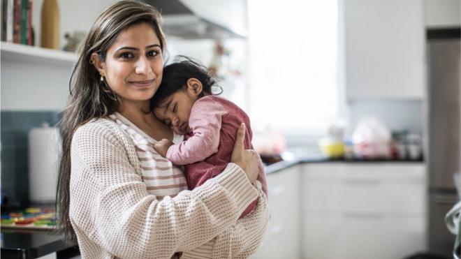 A woman holding a baby