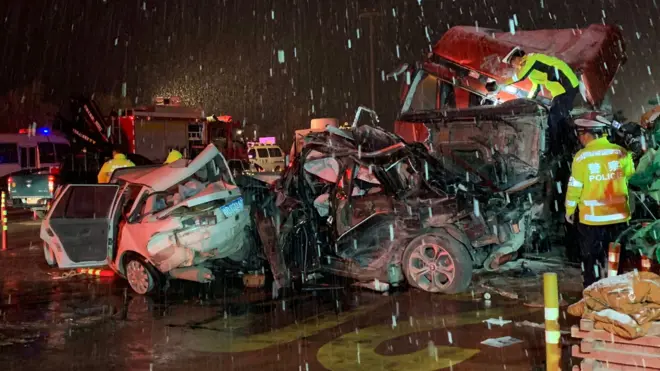 Chinese police officers and rescuers work at the site of where a truck ploughed into cars at a toll booth in Lanzhou, Gansu province, 4 November 2018.