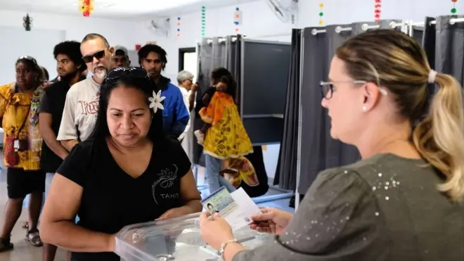 A woman casts her vote at a polling station in the referendum on independence on the French South Pacific territory of New Caledonia in NoumÃ©a on 4 October 2020