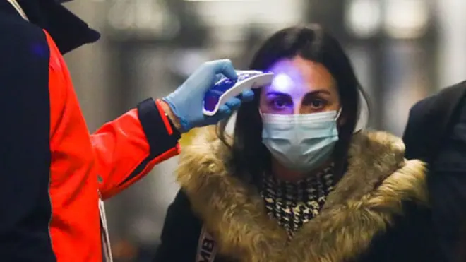 Passengers from Milano, Italy, have their temperatures checked at Krakow Airport in Balice, Poland