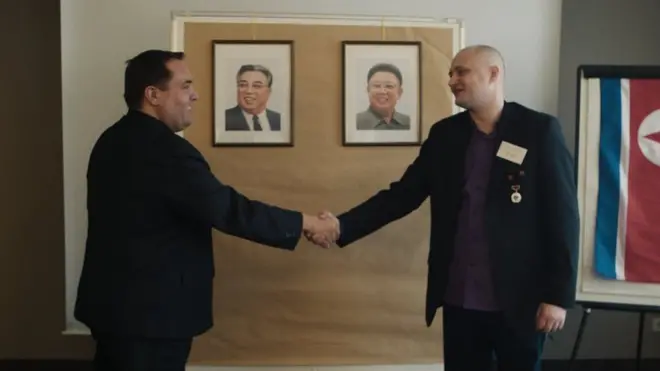 Alejandro Cao de Benós (left) and Ulrich Larsen shaking hands at a KFA meeting in Germany