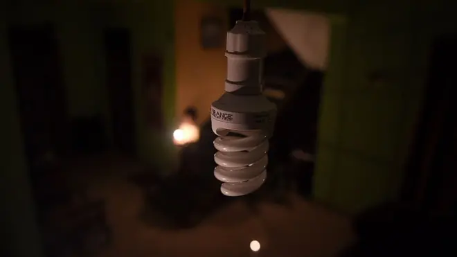A CFL bulb in a dimly lit background.