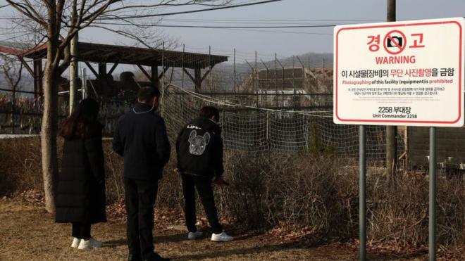 A North Korean defector family pay tribute to ancestors at a spot near the DMZ border