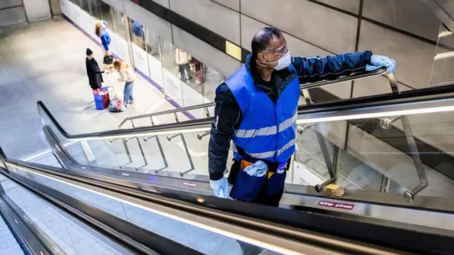A cleaner in the strangely quiet Copenhagen metro