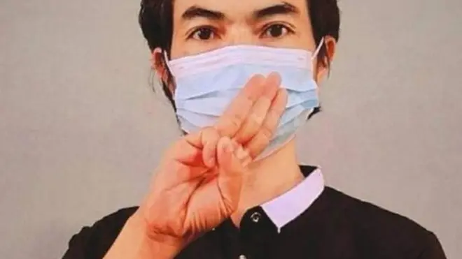 Agne Lay flashes a gesture in support for Burma's civilian opposition