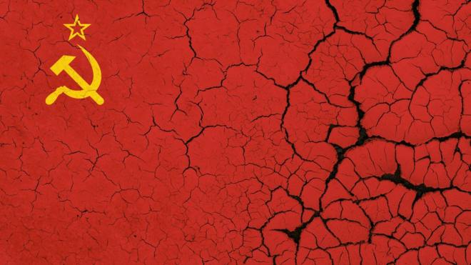 Image of the Soviet flag on parched, dry earth with cracks