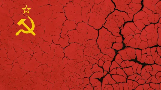 Image of the Soviet flag on parched, dry earth with cracks