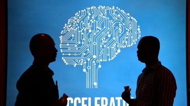 Участники Intel's Artificial Intelligence (AI) Day на фоне постера во время мероприятия в индийском городе Бангалор, 4 апреля 2017 года