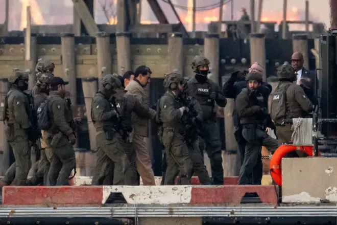 Captured Venezuelan President Nicolas Maduro is escorted, as he heads towards the Daniel Patrick Moynihan United States Courthouse in Manhattan for an initial appearance to face U.S. federal charges including narco-terrorism, conspiracy, drug trafficking, money laundering and others, at Downtown Manhattan Heliport, in New York City, U.S., January 5, 2026.