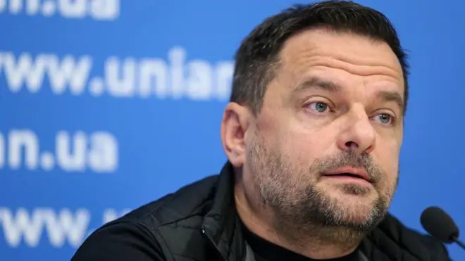 Dmytro Sherembey speaks during a news conference. He has short dark hair.