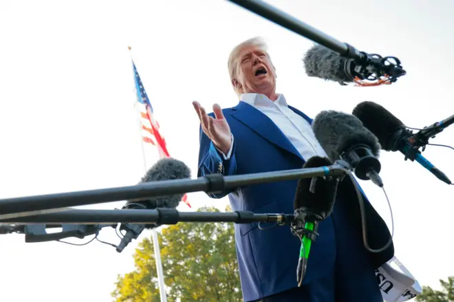 US President Donald Trump speaks to reporters before boarding the Marine One presidential helicopter 