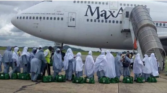 Awọn obinrin to fẹ rinrin ajo lọ fun Hajj wọ ankara alawọ ewe, da iborun funfun bora, wọn n wọ inu baalu