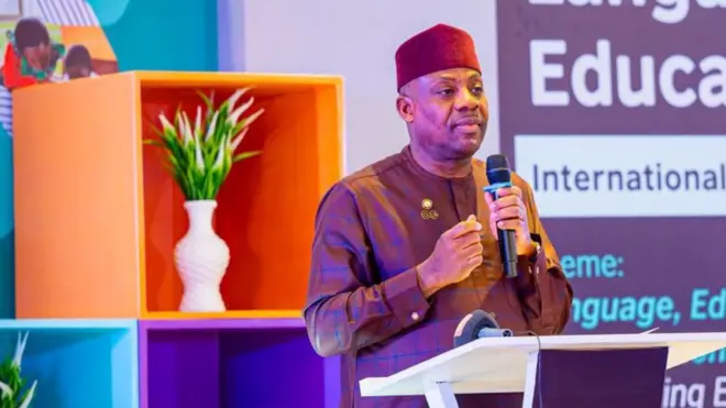 Nigeria Minister of Education Tunji Alausa wear brown native hold microphone