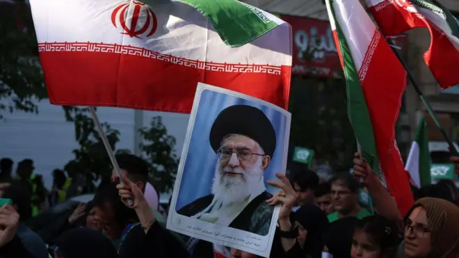 An Iranian woman holds a poster of Iranian supreme leader Ayatollah Ali Khamenei during an anti-Israel rally in Tehran, Iran, 14 June 2025.