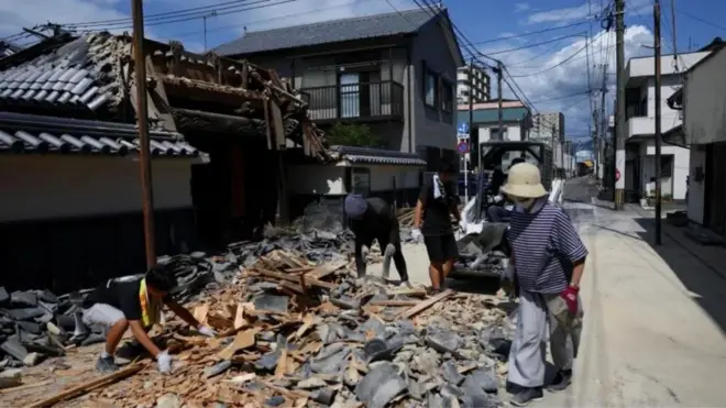 Clean up efforts don start as pipo dey remove debris from one collapsed gate for one temple foir Yatsushiro