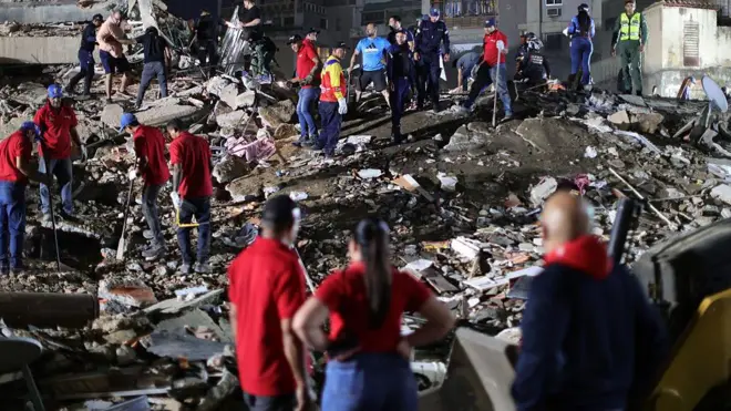 Responders search for victims in a demolished building at San Bernardino after a magnitude 7.2 earthquake struck Venezuela and other regions in the Caribbean on June 24, 2026 in Caracas, Venezuela.