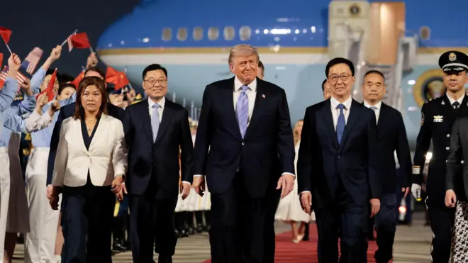 Trump walks along tarmac from Air Force One in Beijing on Wednesday evening