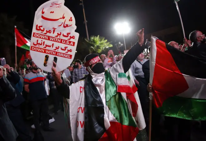 Iranians celebrate after Hamas militants launch surprise strike against Israel