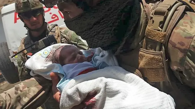 A soldier carries a baby to safety after militants launched an attack