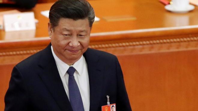 Chinese President Xi Jinping looks on after dropping his ballot during a vote
