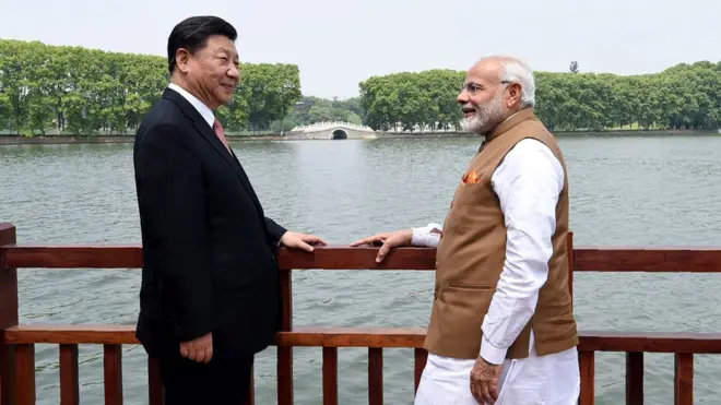 Prime Minister Narendra Modi (R) and Chinese President Xi Jinping looking on along the East Lake, in Wuhan.