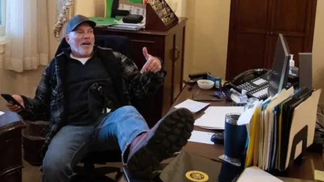 Richard Barnett, a supporter of President Donald Trump sits inside the office of Speaker of the House Nancy Pelosi as he protest inside the US Capitol in Washington, DC, 6 January 2021.