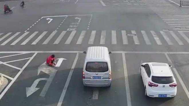 Cars continued on their journeys while Mr Cai worked