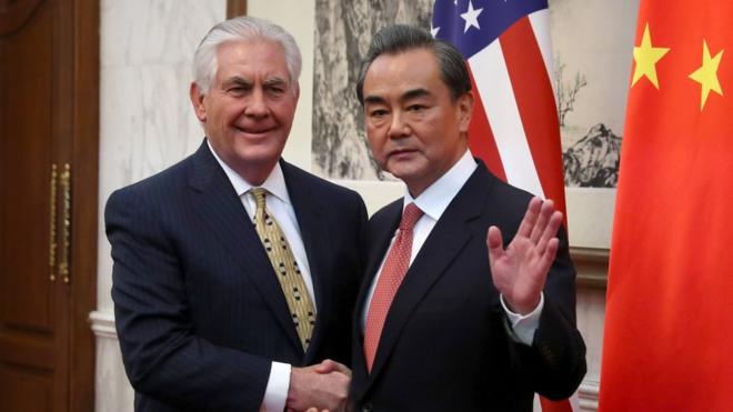 China's Foreign Minister Wang Yi (R) gestures while shaking hands with U.S. Secretary of State Rex Tillerson before a bilateral meeting at the Diaoyutai State Guesthouse in Beijing on March 18, 2017.