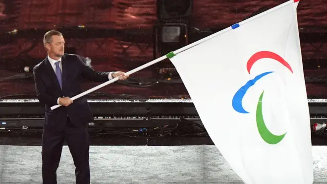 IPC President Andrew Parsons hands over the Paralympic flag during the closing ceremony of the Paris 2024 Summer Paralympic Games at the Stade de France, Paris