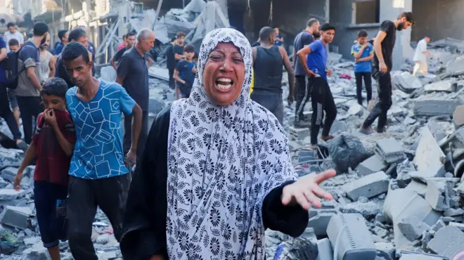A woman reacts following an overnight Israeli air strike on a house in Gaza City, northern Gaza (16 September 2025)