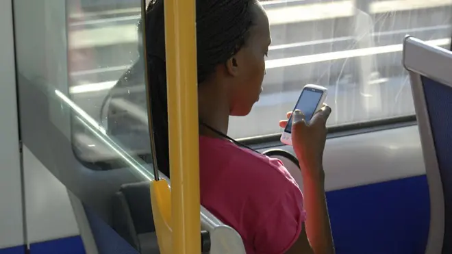 Girl wey dey press phone inside bus