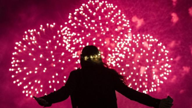 A young girl watches fireworks display during New Year celebrations in Sydney, Australia