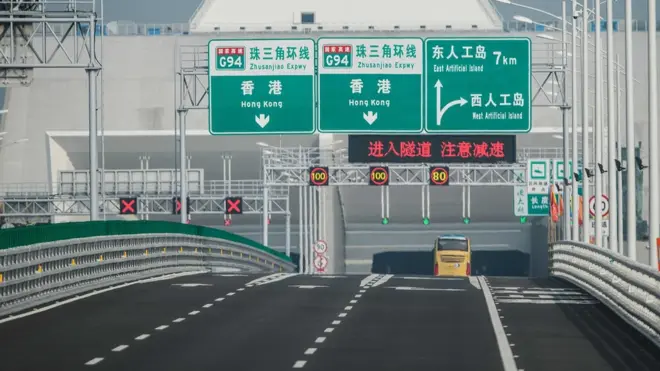 A bus is driven into the under-sea tunnel of the West Artificial Island towards Hong Kong on a section of the Hong Kong-Macau-Zhuhai Bridge on October 24, 2018. - The world's longest sea bridge connecting Hong Kong, Macau and mainland China opened to traffic on October 24 after President Xi Jinping announced its launch at an official ceremony on October 23.