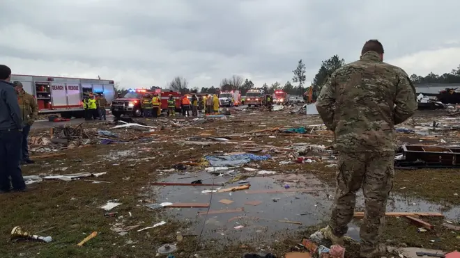 A U.S. Air Force airman surveys debris covering an area of the Sunshine Acres neighborhood after a tornado struck Adel, Georgia, U.S. January 22, 2017
