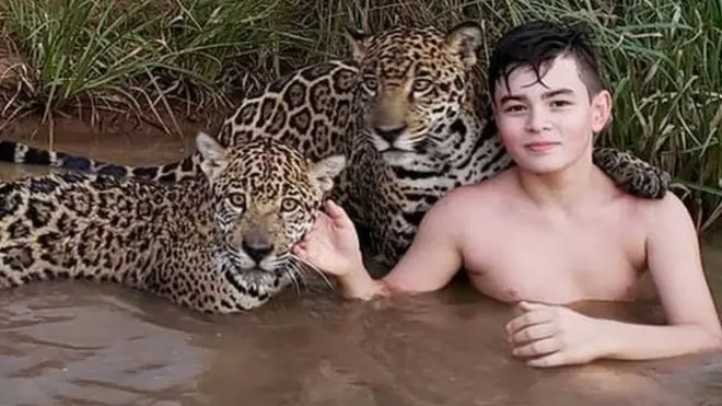 This photo of Tiago with jaguars went viral - one even appears to hug him