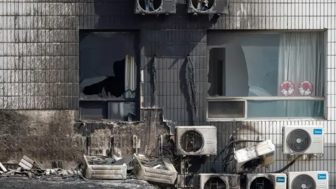 A view of broken windows and burned air conditioners following a fire at the Changfeng Hospital in Beijing