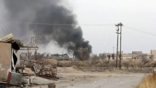 Smoke rises from the town of Bashiqa as government forces continue their offensive on Mosul, 10 November 2016