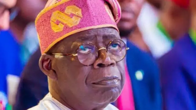 A man identified as Bola Tinubu wit glasses and native cap